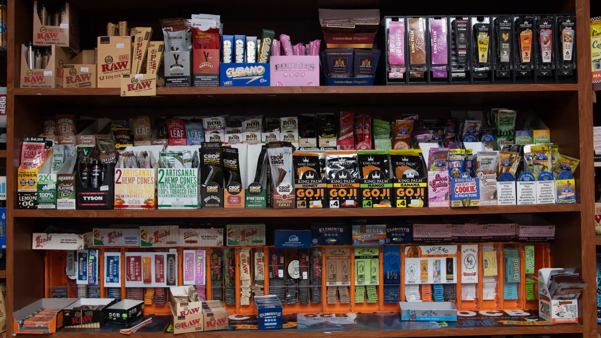 Shelves of rolling papers, hemp cones and wraps, including RAW, Elements and Zig-Zag